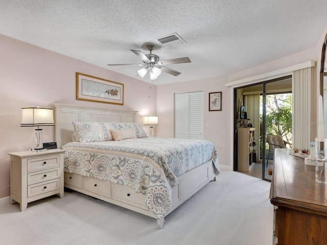 6417 Meadowlark Ln Unit 6417, Bradenton, FL 34210 - bedroom featuring a textured ceiling, baseboards, visible vents, and light carpet
