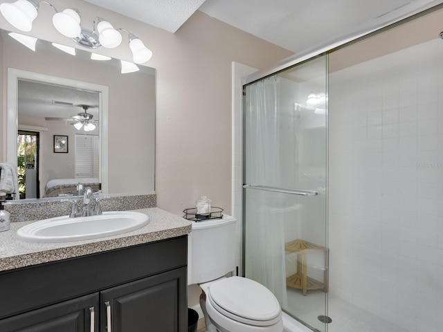 bathroom with a shower with door, a textured ceiling, toilet, ceiling fan, and vanity