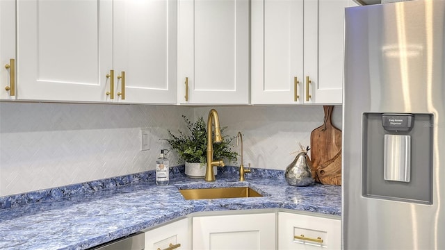 kitchen featuring sink, white cabinets, and appliances with stainless steel finishes