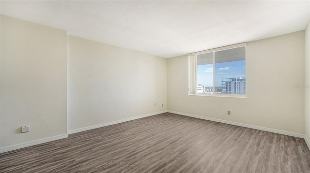 spare room with wood-type flooring