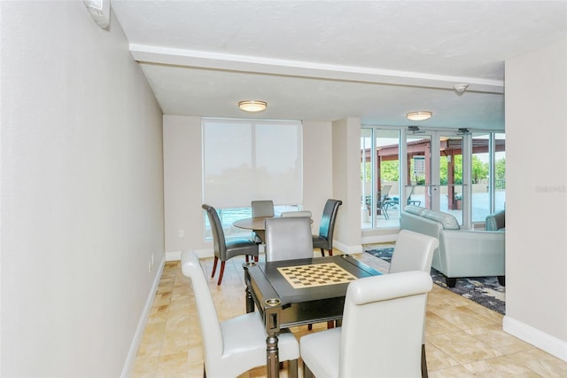 dining space featuring french doors and a wall of windows