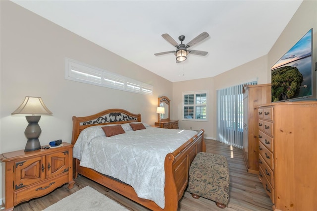 bedroom with light hardwood / wood-style floors and ceiling fan