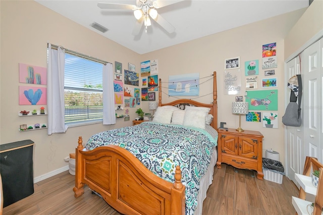 bedroom featuring a closet, light wood-type flooring, and ceiling fan