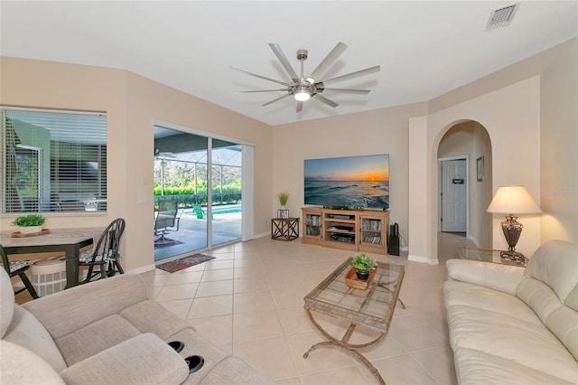 tiled living room with ceiling fan