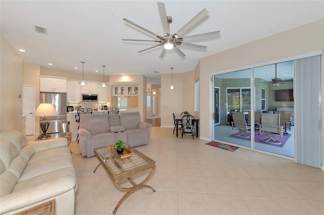 living room with ceiling fan and light tile patterned floors