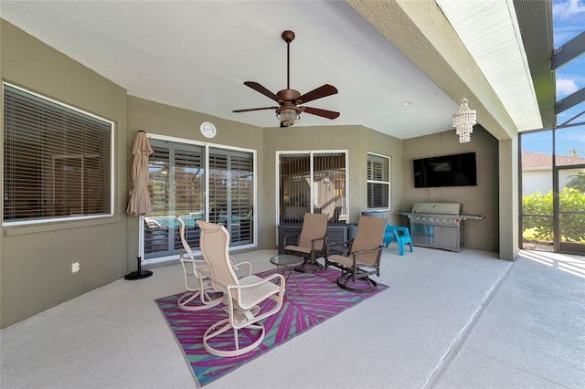 view of patio featuring ceiling fan, a lanai, and a grill