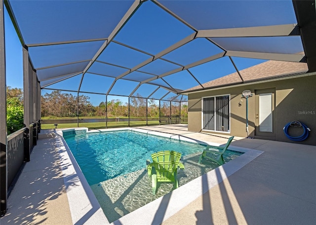 view of swimming pool with a patio area and a lanai