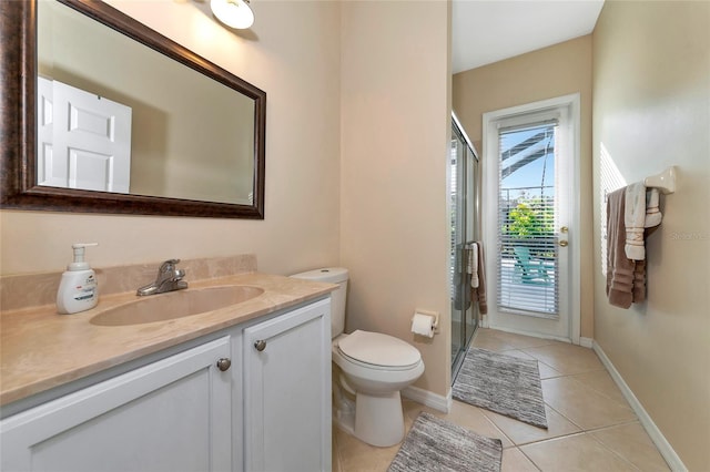 bathroom with vanity, an enclosed shower, toilet, and tile patterned floors