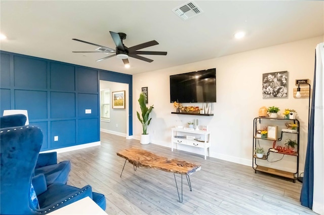 living room featuring ceiling fan and light wood-type flooring