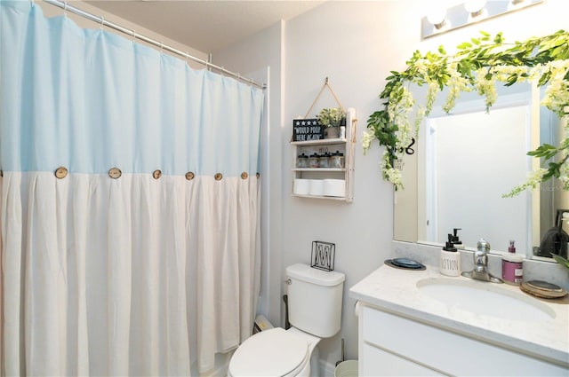 bathroom with vanity, toilet, and walk in shower