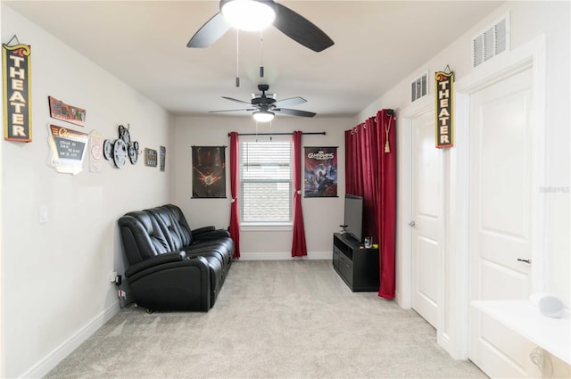 living area with light colored carpet and ceiling fan