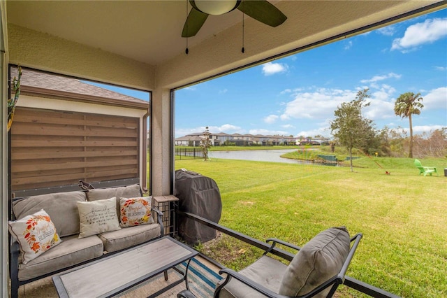 exterior space featuring a water view and ceiling fan