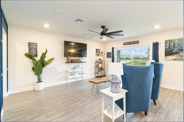 sitting room with ceiling fan and light wood-type flooring