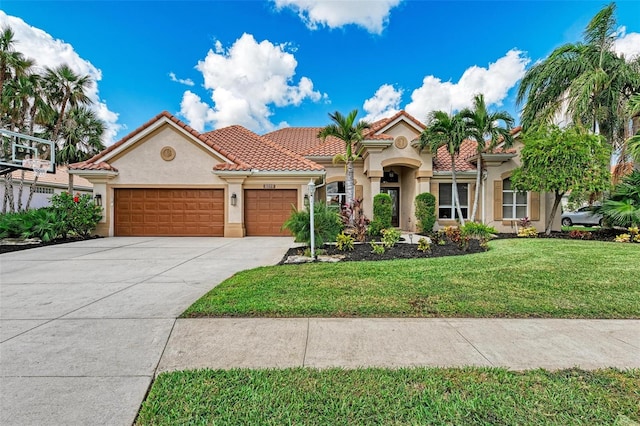 mediterranean / spanish-style house featuring a front lawn and a garage