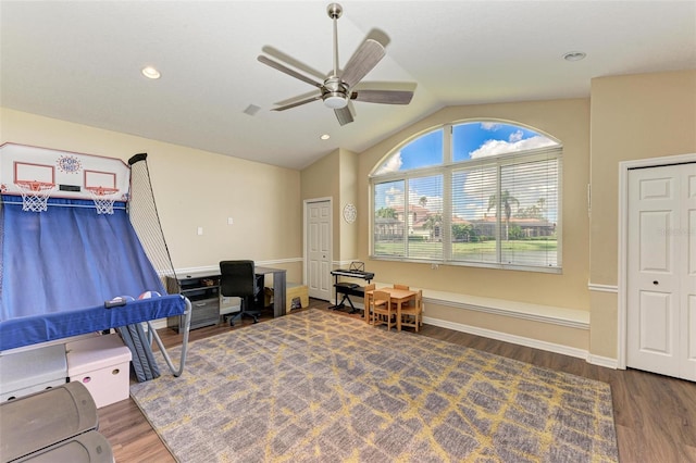 interior space with ceiling fan, lofted ceiling, and dark wood-type flooring