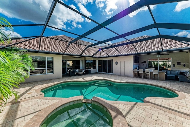 view of pool featuring an in ground hot tub, an outdoor living space, ceiling fan, a patio, and an outdoor bar