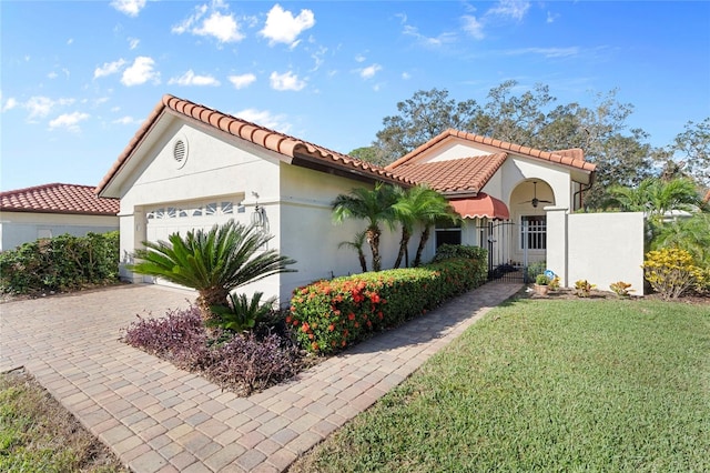 mediterranean / spanish house with a front yard and a garage