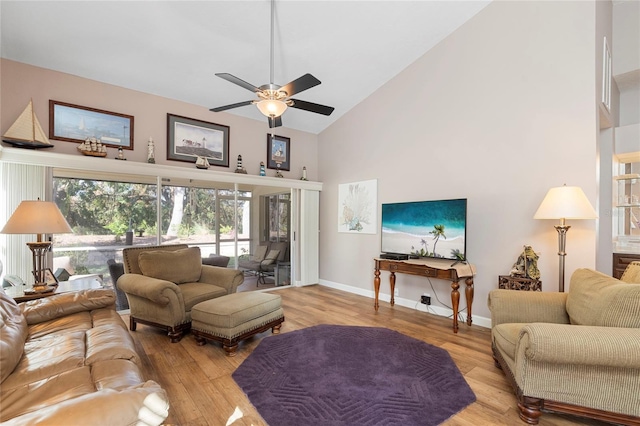 living room featuring light hardwood / wood-style floors, high vaulted ceiling, and ceiling fan