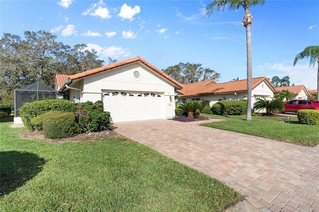 view of front of house featuring a front lawn, a lanai, and a garage