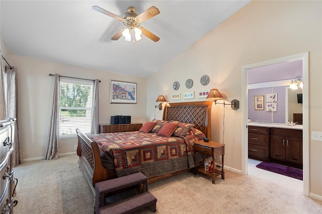 carpeted bedroom featuring ensuite bathroom, vaulted ceiling, and ceiling fan