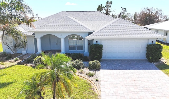 view of front of home featuring a garage and a front lawn