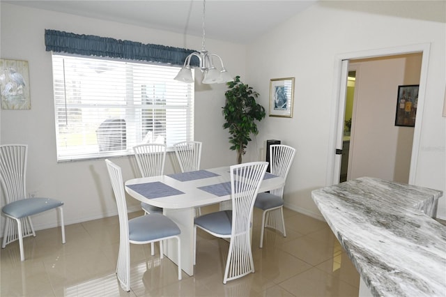 dining area featuring light tile patterned floors, lofted ceiling, and an inviting chandelier