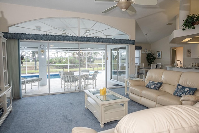 carpeted living room with vaulted ceiling and ceiling fan