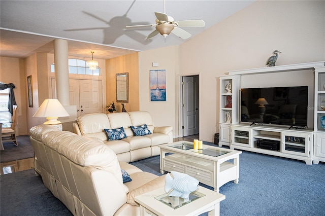 living room with ceiling fan and dark colored carpet