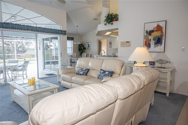 carpeted living room with vaulted ceiling