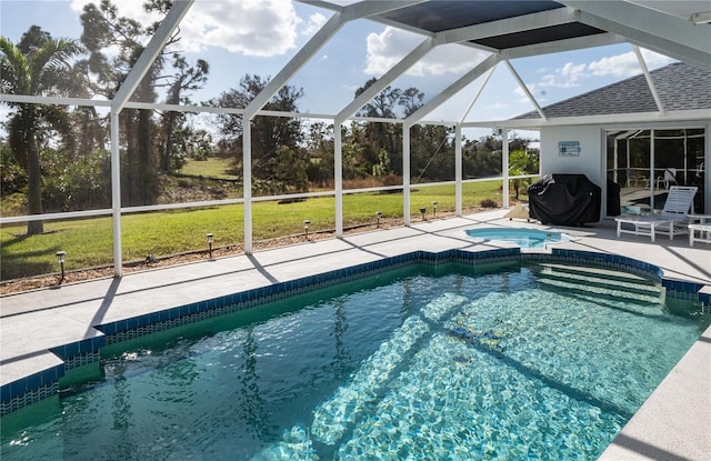 view of swimming pool featuring an in ground hot tub, area for grilling, a patio, a lanai, and a lawn