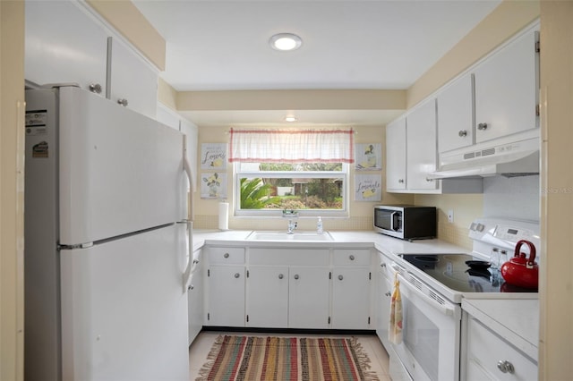 kitchen featuring white appliances, sink, and white cabinets