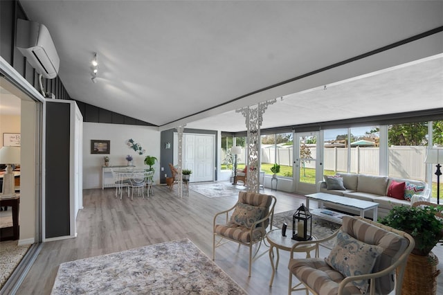 living room featuring lofted ceiling, expansive windows, a wall mounted air conditioner, and light hardwood / wood-style floors