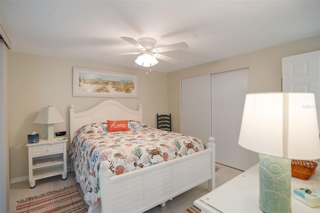 tiled bedroom with a closet and ceiling fan