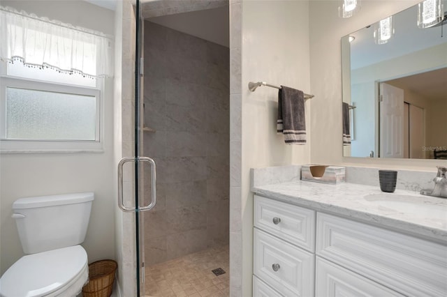 bathroom featuring vanity, toilet, and walk in shower