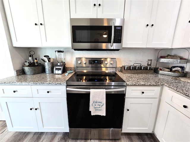 kitchen featuring appliances with stainless steel finishes, white cabinetry, and dark hardwood / wood-style flooring