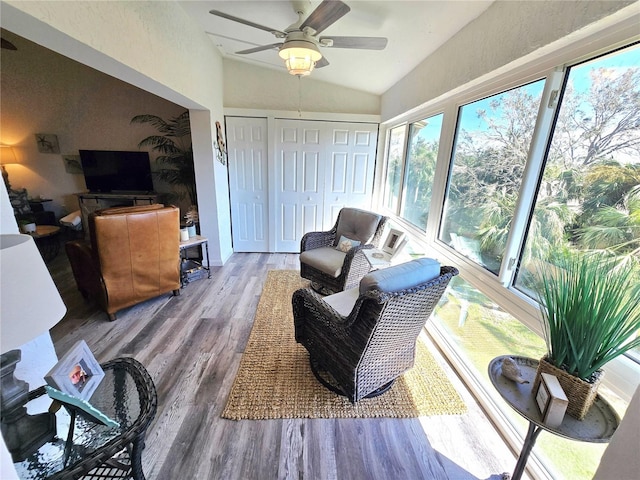 sunroom with ceiling fan and lofted ceiling