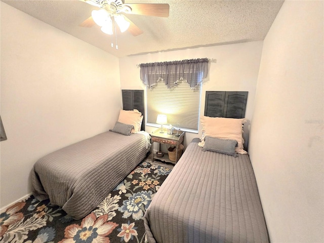 bedroom with a textured ceiling and ceiling fan