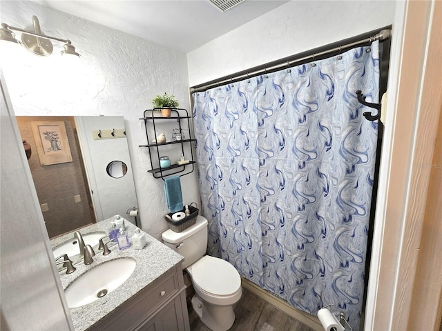 bathroom featuring vanity, toilet, wood-type flooring, and curtained shower