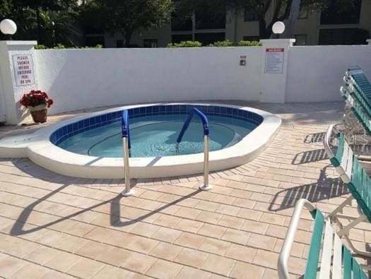 view of pool with a community hot tub