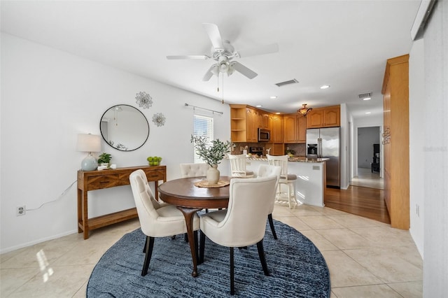 dining space featuring ceiling fan and light tile patterned floors