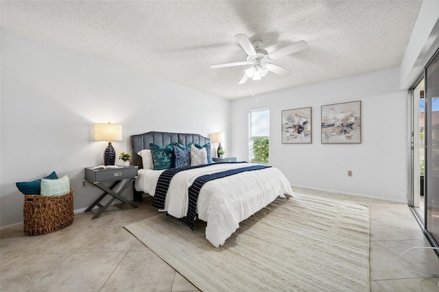 tiled bedroom featuring ceiling fan and a textured ceiling