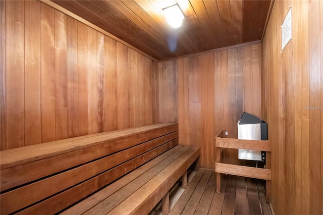 view of sauna with wood ceiling, wooden walls, and wood-type flooring