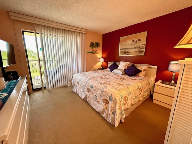 carpeted bedroom featuring access to outside and a textured ceiling