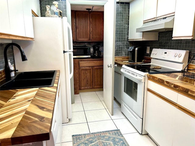 kitchen with tasteful backsplash, sink, white range with electric cooktop, white cabinets, and light tile patterned floors