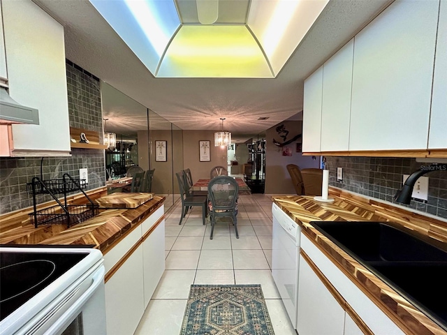 kitchen with decorative backsplash and white cabinets