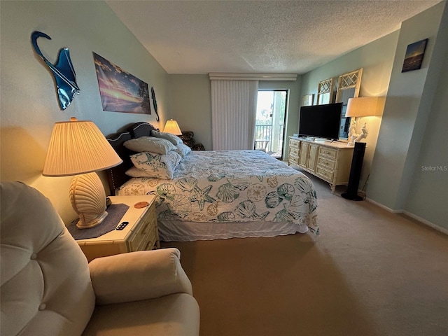 carpeted bedroom with access to outside and a textured ceiling