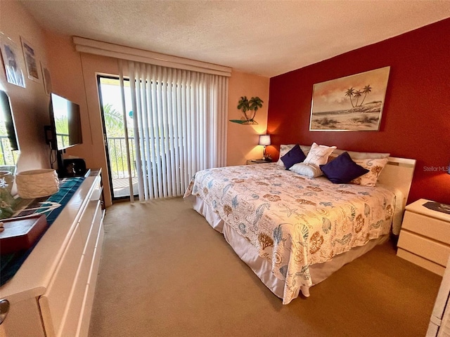 carpeted bedroom with a textured ceiling and access to exterior