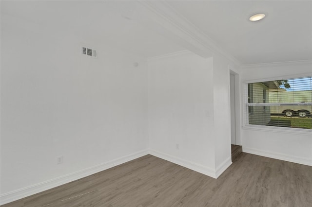 unfurnished room with wood-type flooring and ornamental molding