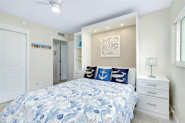 bedroom featuring a closet, light wood-type flooring, and ceiling fan