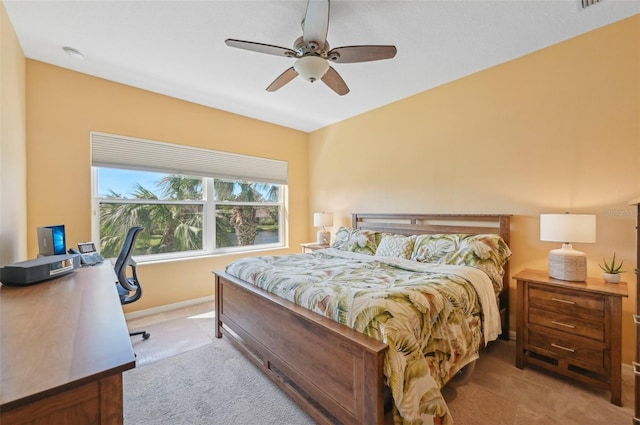 bedroom featuring ceiling fan and light carpet